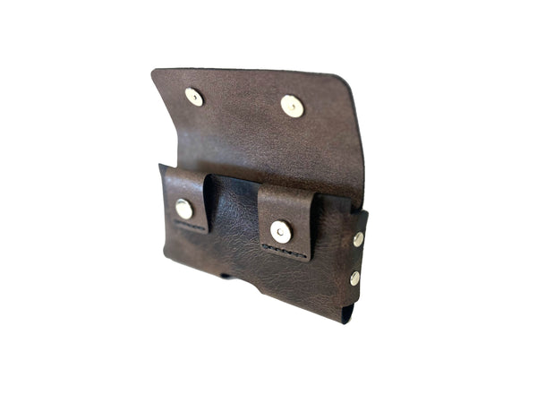 Brown leather phone holster with metal snaps on a white background