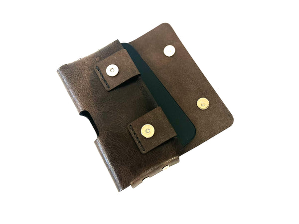 Brown leather phone holster with the closure flap open on a white background